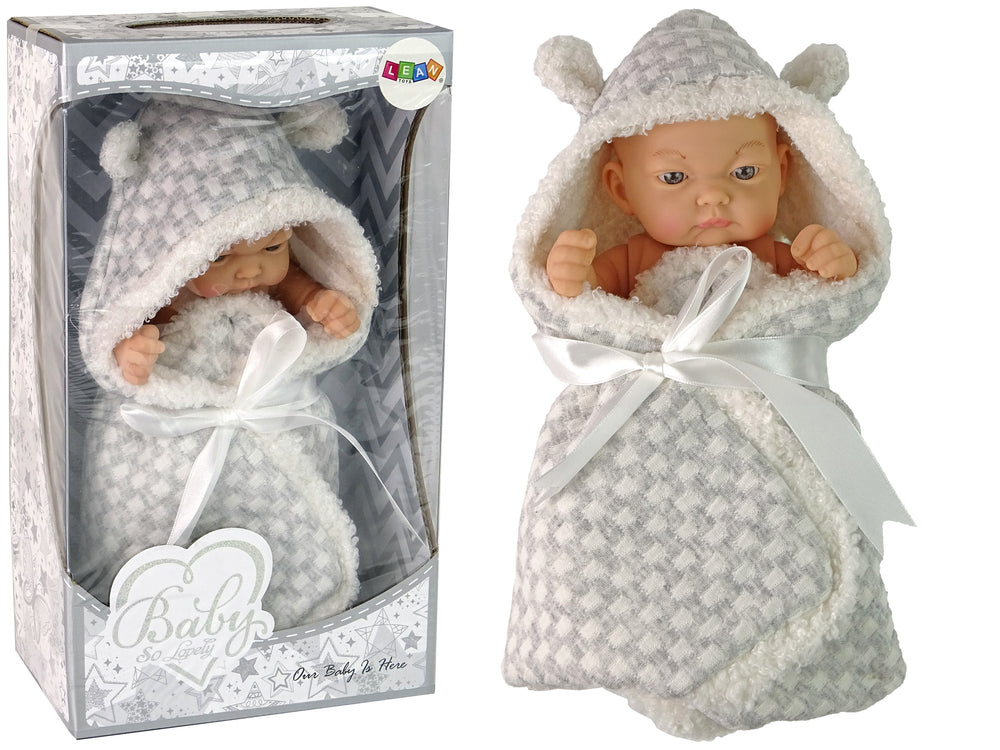 Babydocka med grå swaddle och rosett